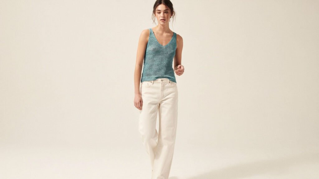 Dusty rose crochet tie-front crop top with knotted centre detail and two-panel construction styled with white linen trousers