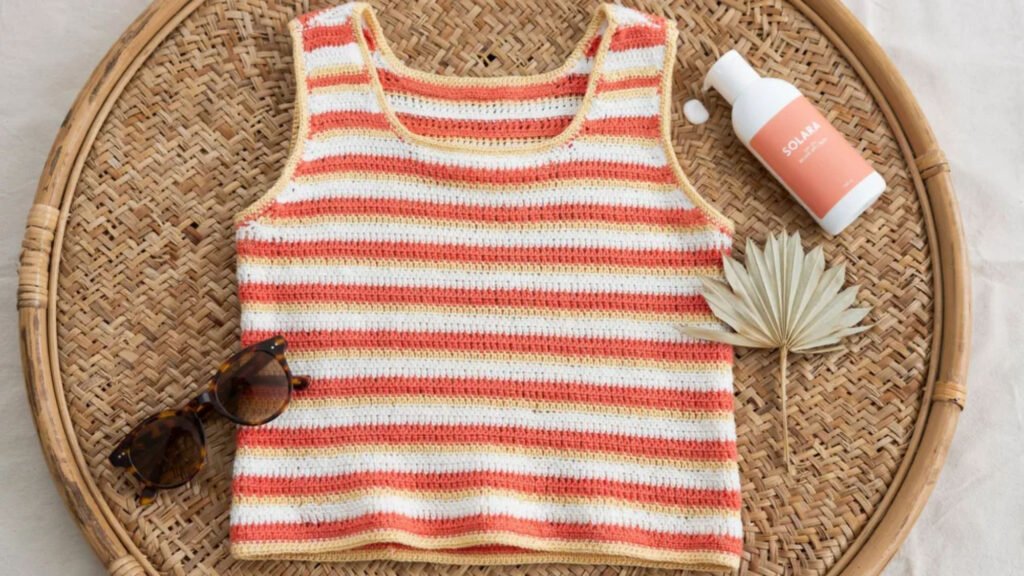 Soft lilac crochet short sleeve tee in cotton yarn with rectangular seamed sleeves worn with white shorts