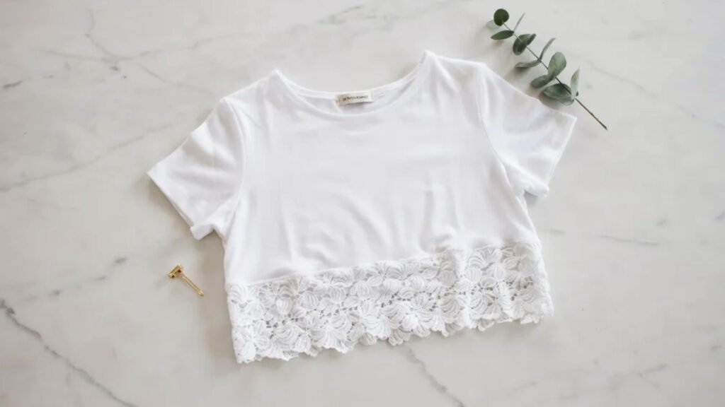 Handmade white cotton crochet bralette with triangle cups and long adjustable ties showing delicate stitch detail