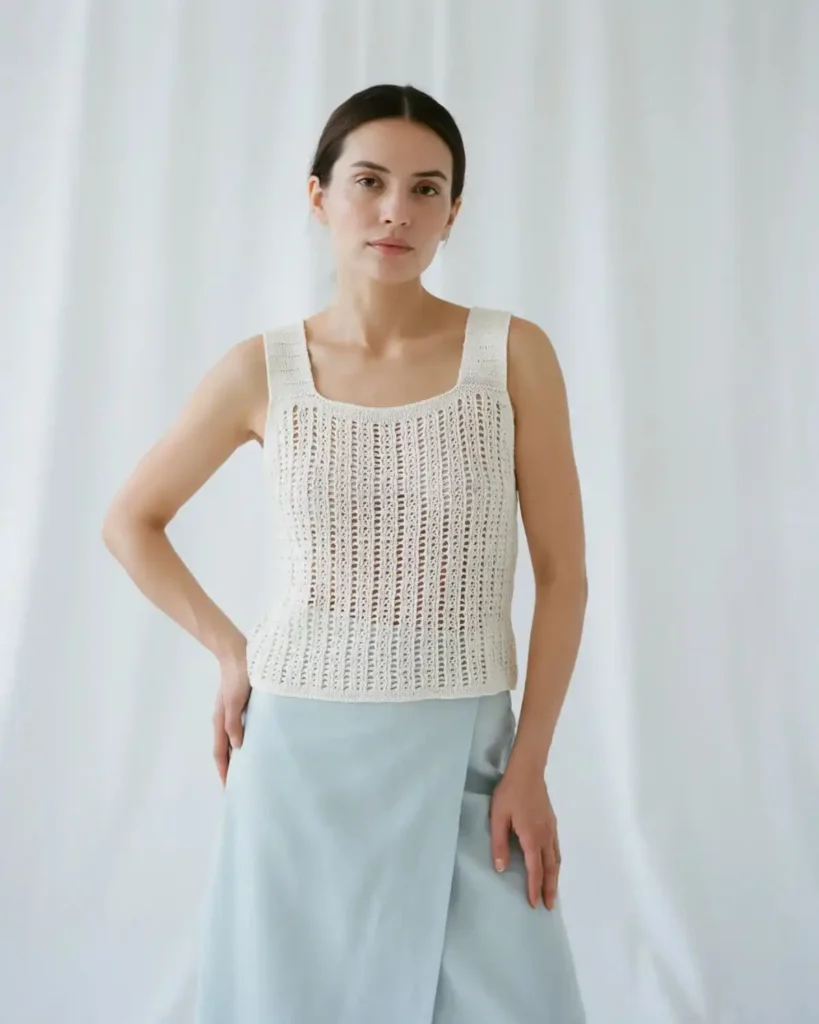 White Salt-Air sleeveless crochet mesh shell with a square neckline and blue linen skirt.