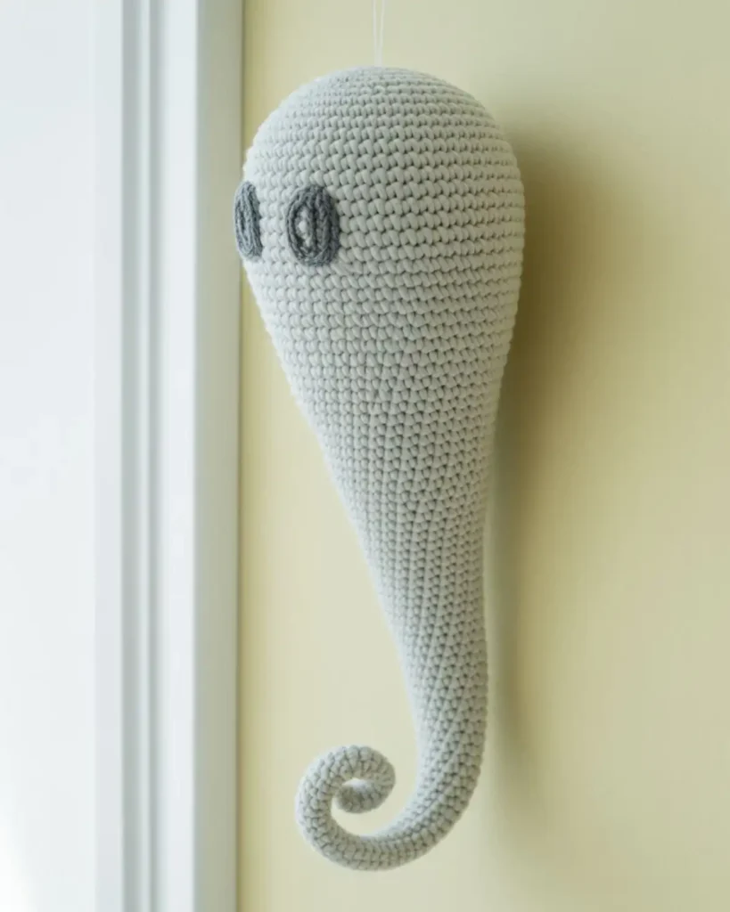 Long-tailed white crochet ghost with a curled spiral end.