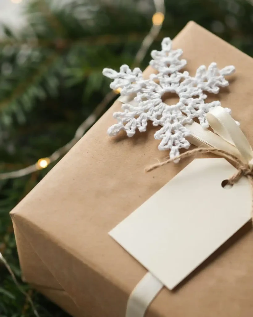 Tiny white crochet thread snowflake decorating a kraft Christmas gift