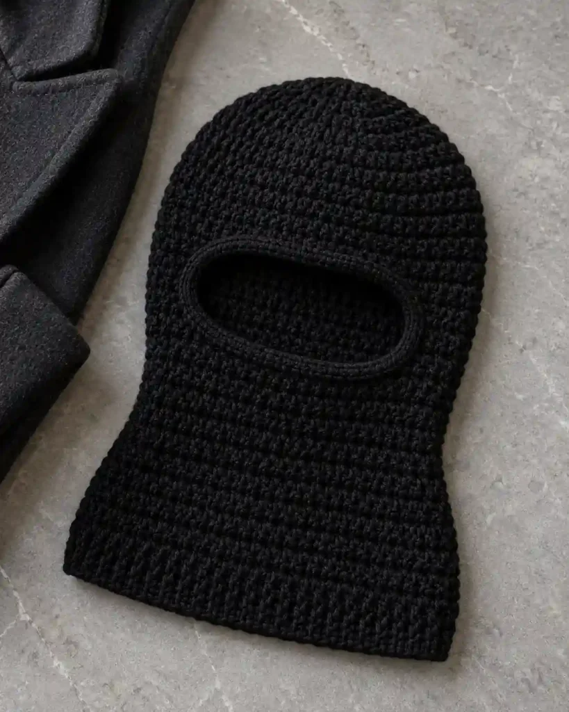 Handmade pink aesthetic crochet balaclava with visible crochet stitches, photographed for a crochet balaclava ideas guide.