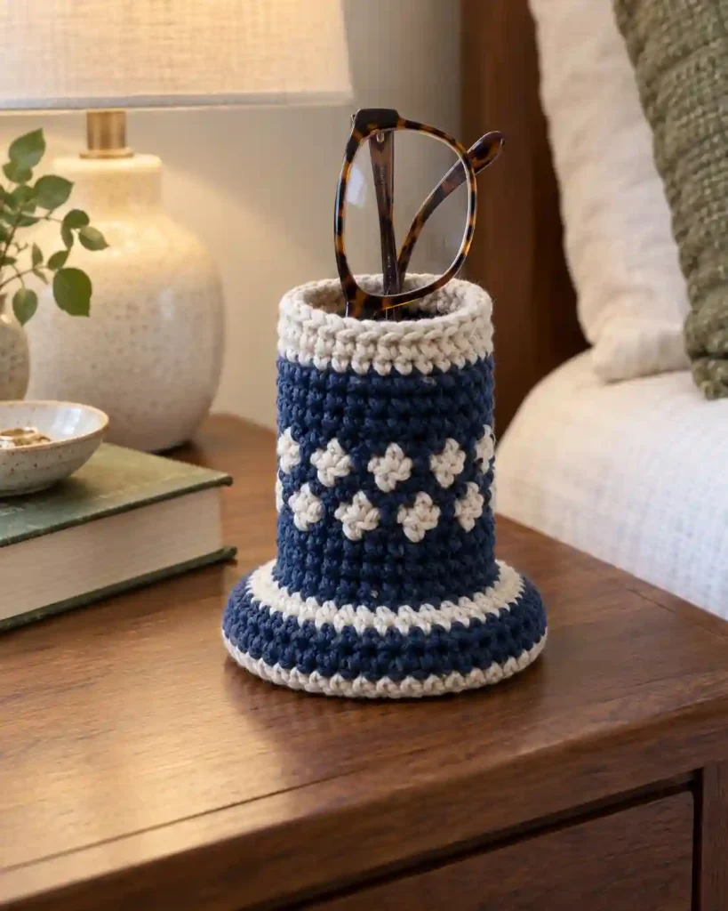 Crocheted eyeglasses holder on a nightstand supporting reading glasses, a practical handmade gift for grandpa