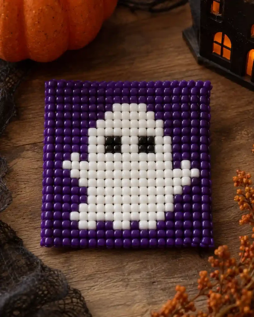 Handmade pony bead tapestry showing smiling ghost on dark violet in a flat pixel-grid panel.