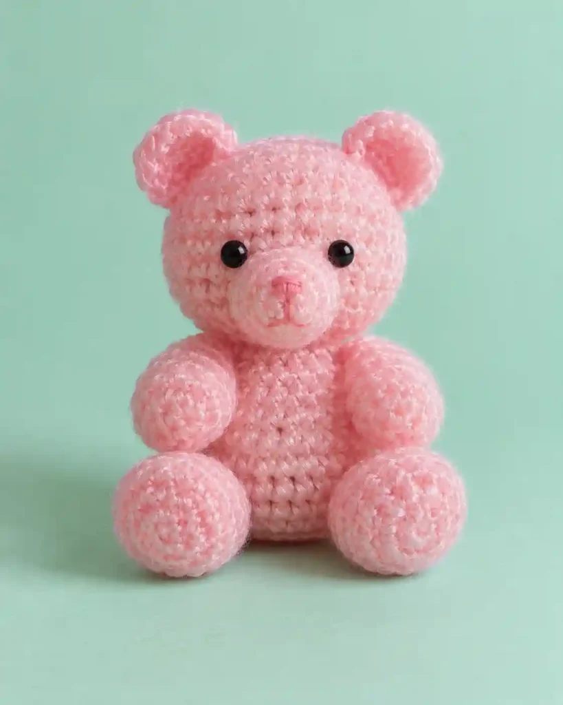 Finished gummy bear crochet amigurumi showing its distinct shape and no-sew integrated details in a clean craft setting.
