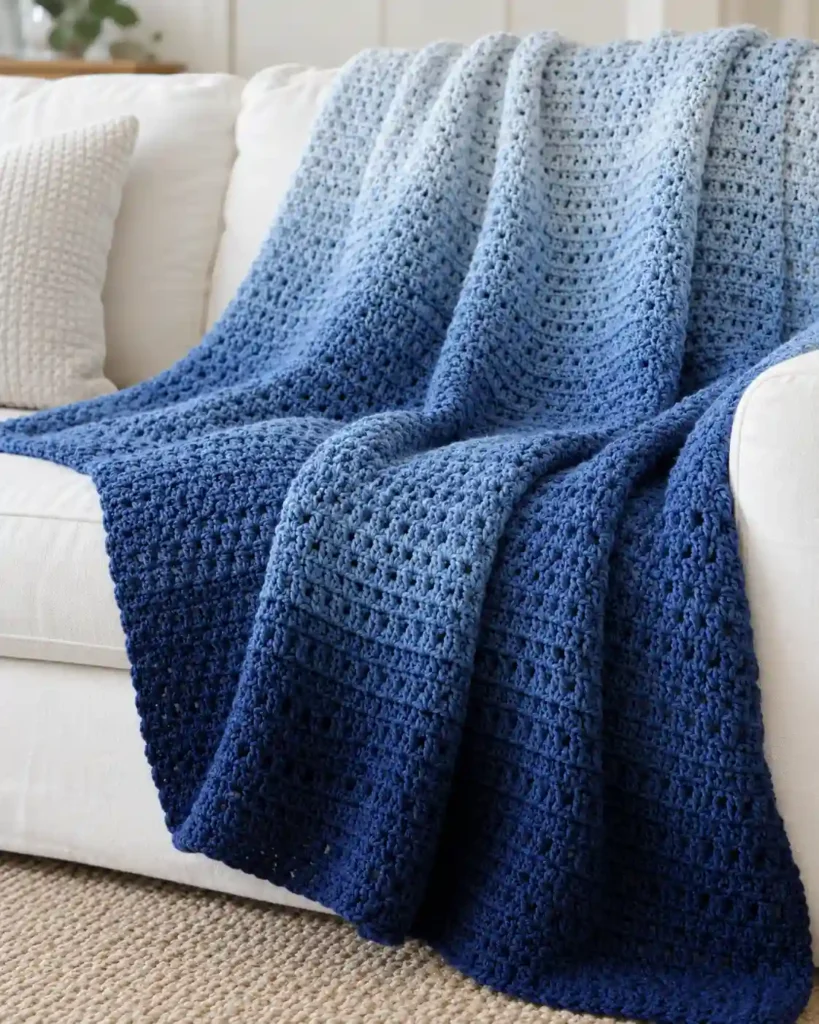Finished blue ombre crochet blanket with realistic crochet stitch details and smooth color gradation.