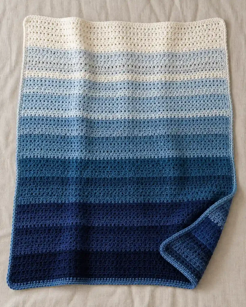 Finished ombre striped crochet blanket with realistic crochet stitch details and smooth color gradation.